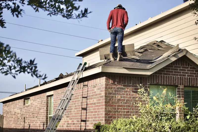 Professional roofer working on a residential roof in Dunkirk